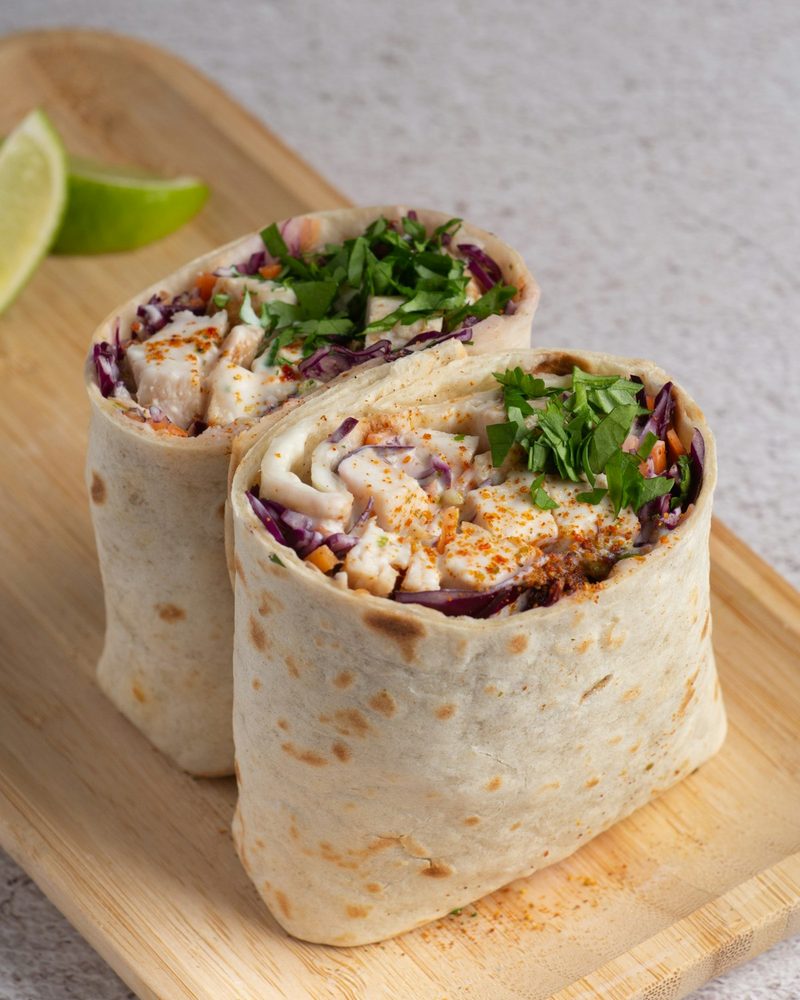 Hand-rolled burrito with a Jarritos