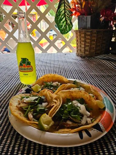 Tacos with a Jarritos soda on the patio